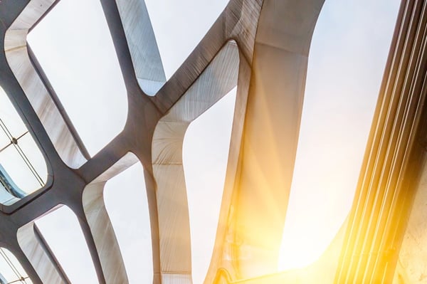 Close-up view of a contemporary building facade featuring glass panels and steel beams.