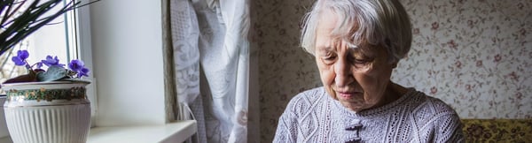 Older person looking at a paper letter