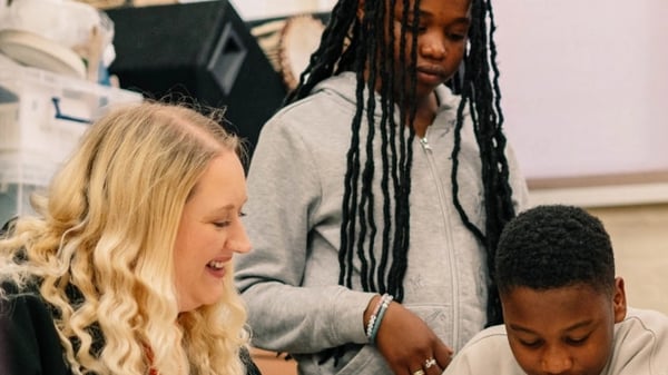 Two young people working on a project with a community leader.