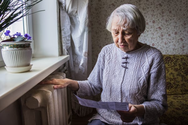 Older person looking at a paper letter